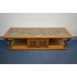 AN ORIENTAL HARDWOOD COFFEE TABLE, the glass insert enclosing heavily carved chinoiserie decoration,