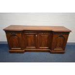 A VICTORIAN FLAME MAHOGANY INVERTED BREAKFRONT SIDEBOARD, left door with slides, right door with