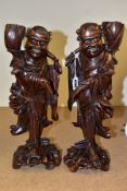 A PAIR OF EARLY 20TH CENTURY CHINESE CARVED HARDWOOD FIGURES OF JOVIAL MEN, with bone teeth, both