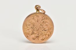 A YELLOW METAL LOCKET PENDANT, of a circular form, engraved foliate design to the front, set with