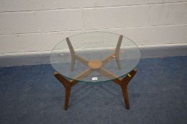 A DANISH STYLE TEAK CIRCULAR GLASS TOP COFFEE TABLE, on four shaped legs united by a small