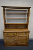 A 19TH CENTURY PINE DRESSER, with an open plate rack, two frieze drawers and panelled doors, width