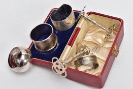 FOUR SILVER NAPKIN RINGS AND TWO KNIFE RESTS, the rest with pierced quatrefoil terminals and band