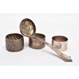 A LATE VICTORIAN SILVER LADLE AND THREE NAPKIN RINGS, the ladle with a textured tapered handle,