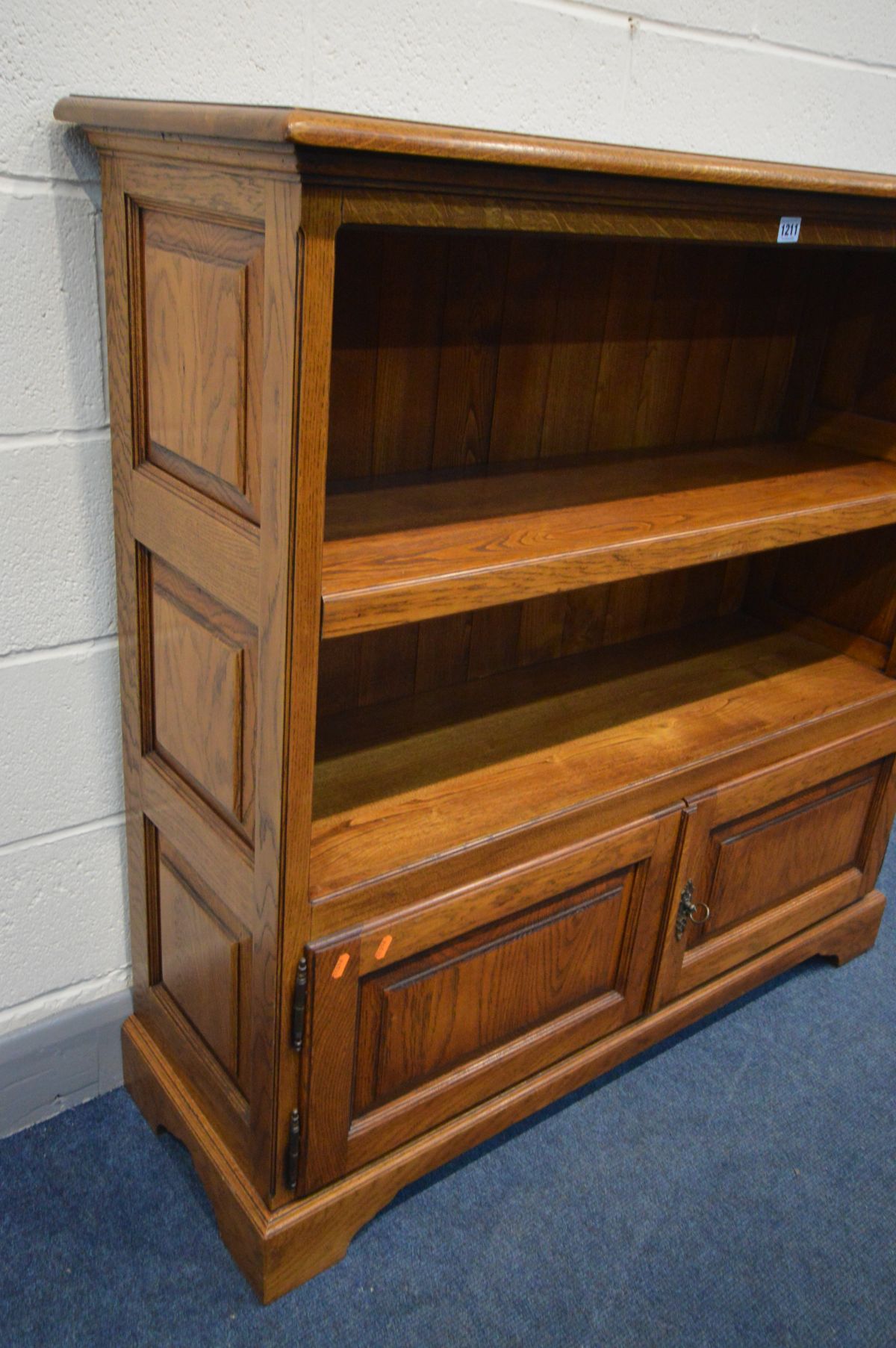 A REPRODUCTION OAK OPEN BOOKCASE, with fielded panels to the sides, single adjustable shelf, above - Image 2 of 2