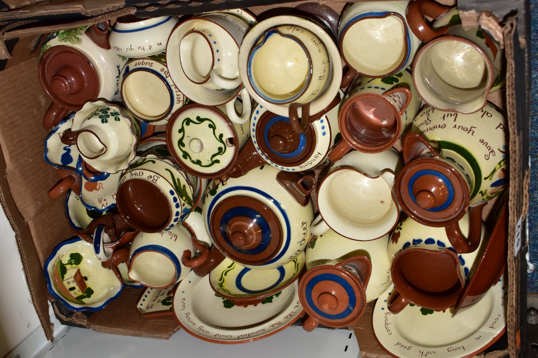 A BOX OF TORQUAY/MOTTO WARE, including two tea pots, hot water jugs, milk jugs, sugar bowls,