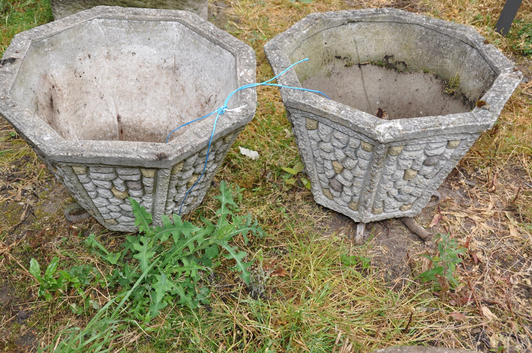 A PAIR OF OCTAGONAL TAPERING COMPOSITE GARDEN PLANTERS with dry stone wall effect panels to each