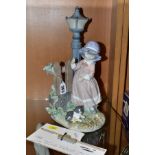 A LLADRO FIGURE, 'Fall Clean Up' (girl with rake near lampost) No.5286, issued in 1985 and retired