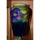 A MOORCROFT POTTERY BALUSTER VASE DECORATED IN THE CLEMATIS PATTERN, on a shaded green/blue
