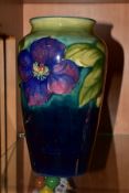 A MOORCROFT POTTERY BALUSTER VASE DECORATED IN THE CLEMATIS PATTERN, on a shaded green/blue