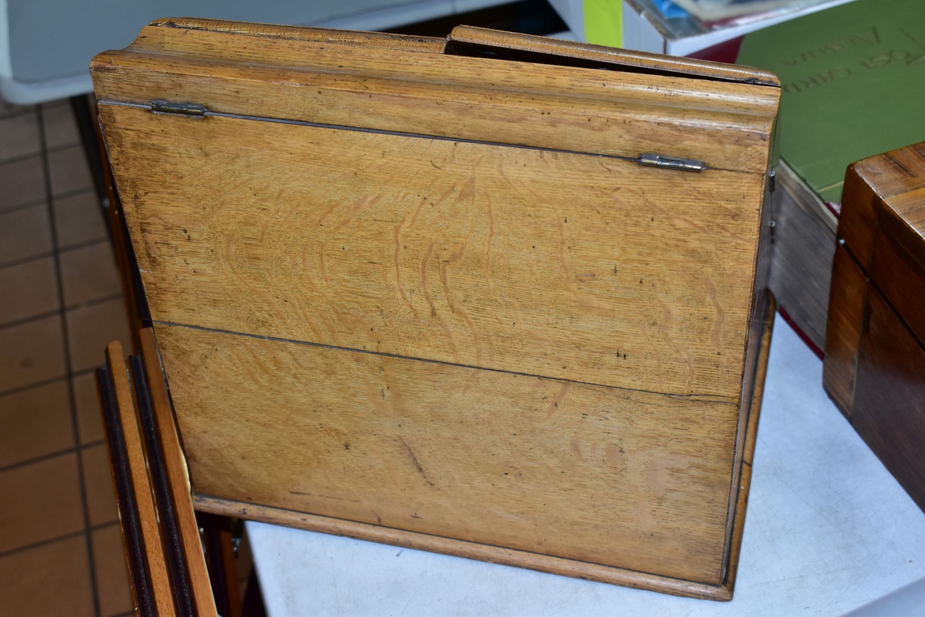 AN EDWARDIAN OAK STATIONERY BOX, hinged top above sloped double doors opening to reveal a fitted - Image 6 of 7