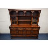 AN OLD CHARM DRESSER, plate rack flanked by single lead glazed cupboard doors, on a base with two