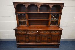 AN OLD CHARM DRESSER, plate rack flanked by single lead glazed cupboard doors, on a base with two