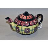 A MOORCROFT POTTERY TEAPOT, 'Violet' pattern designed by Sally Tuffin, impressed backstamp and
