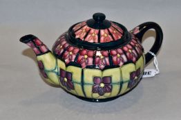 A MOORCROFT POTTERY TEAPOT, 'Violet' pattern designed by Sally Tuffin, impressed backstamp and