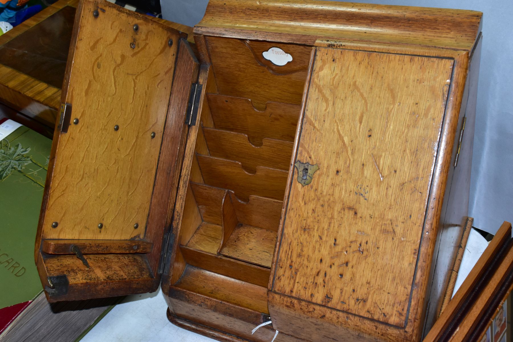 AN EDWARDIAN OAK STATIONERY BOX, hinged top above sloped double doors opening to reveal a fitted - Image 7 of 7