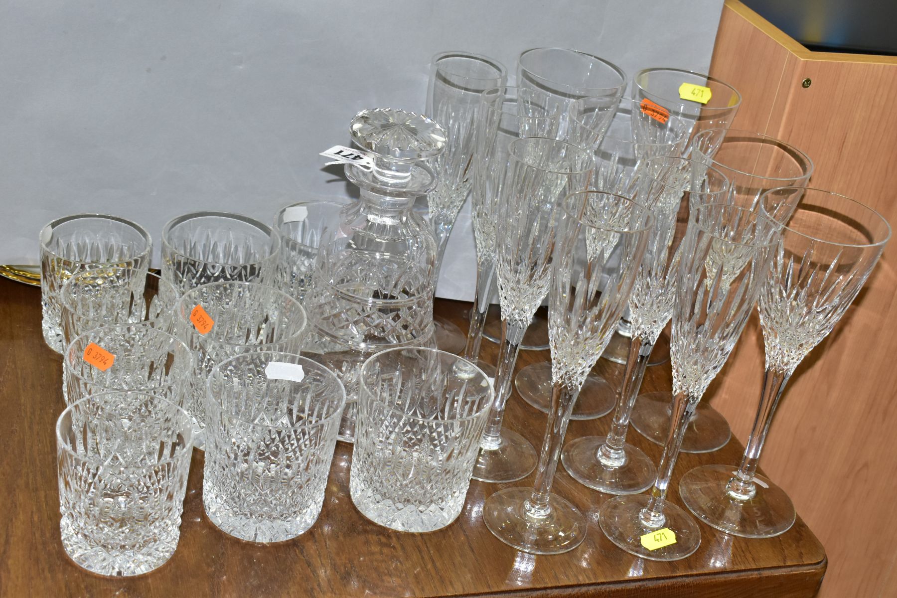 A SUITE OF STUART CRYSTAL DRINKING GLASSES AND A STUART CRYSTAL DECANTER, the decanter of bell shape