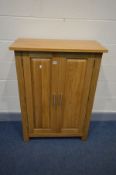 AN OAK STATIONERY CABINET, the double panelled door enclosing five slopped shelves, width 80cm x