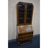 A EARLY TO MID 20TH CENTURY OAK BUREAU BOOKCASE, the top section with Art Deco lead glazed doors,