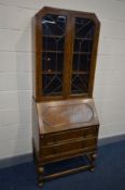 A EARLY TO MID 20TH CENTURY OAK BUREAU BOOKCASE, the top section with Art Deco lead glazed doors,