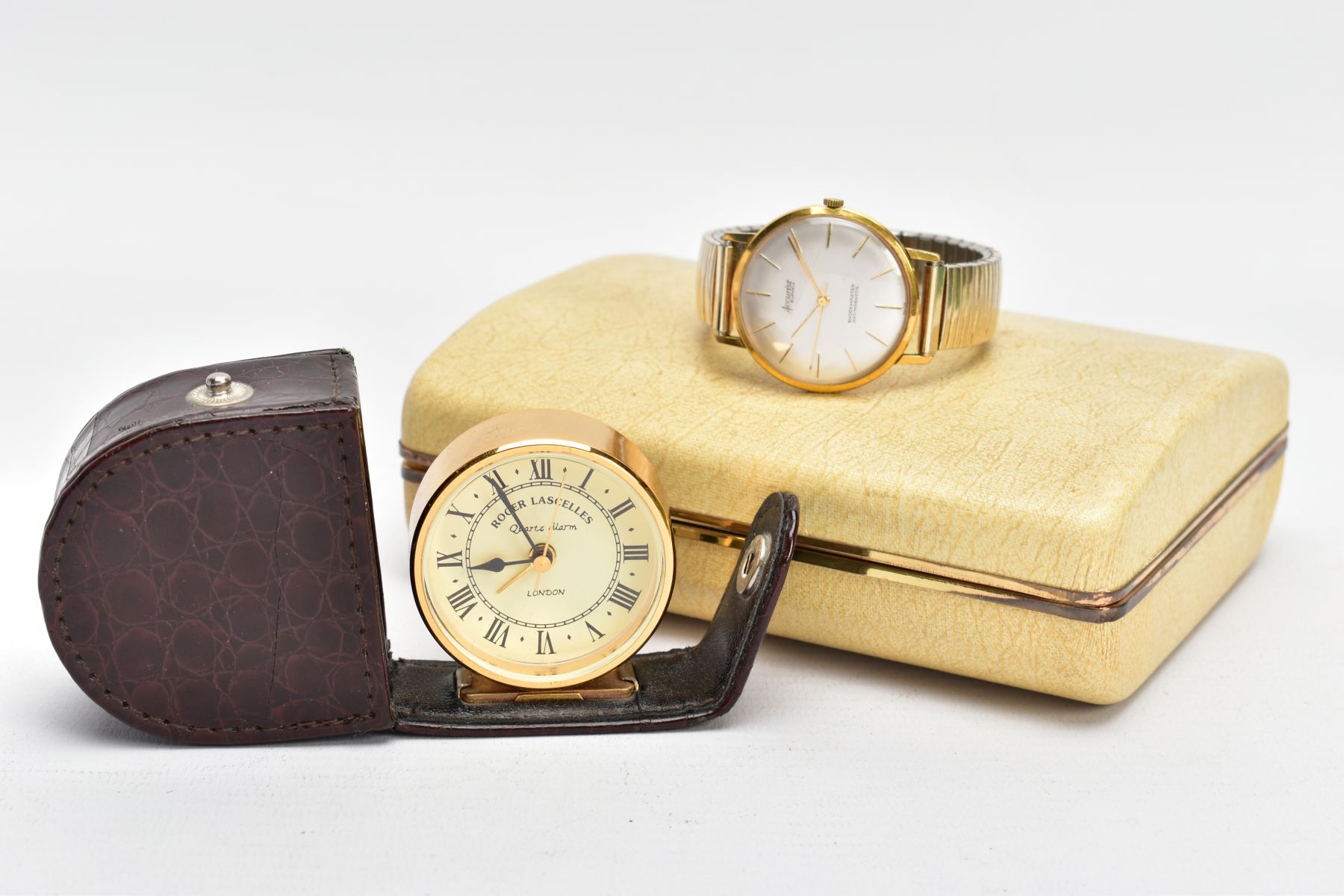 A GENTS WRISTWATCH AND A TRAVEL CLOCK, to include a gents hand wound movement, 'Accurist' round