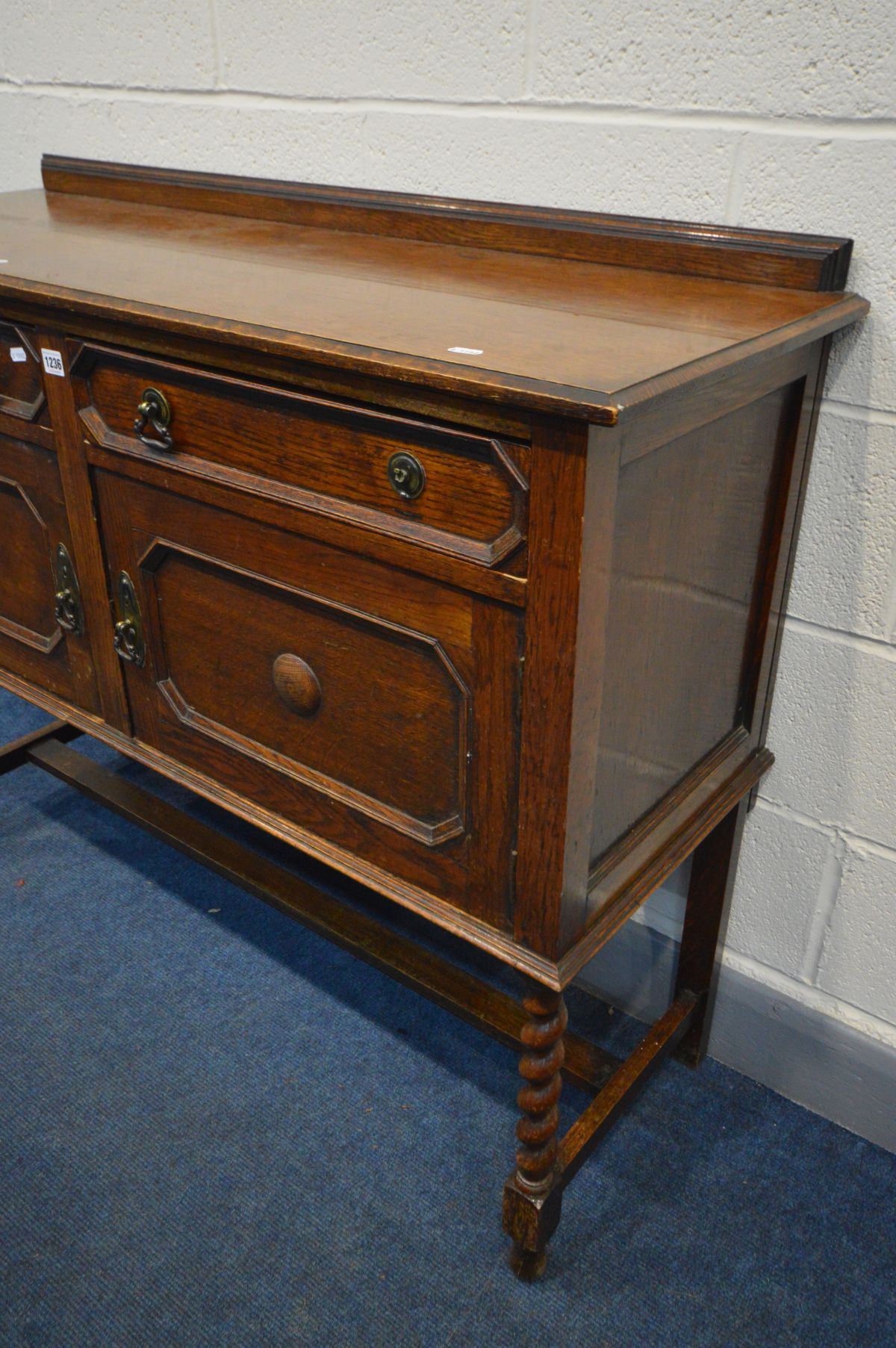 AN EARLY 20TH CENTURY OAK SIDEBOARD, two drawers above two cupboard doors, barley twist front - Image 2 of 2