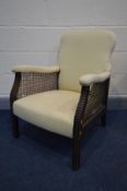 AN EARLY 20TH CENTURY OAK BERGERE ARMCHAIR (Sd to bergère, see image)