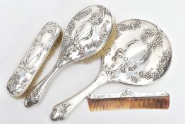 A FOUR PIECE SILVER VANITY SET, to include a hairbrush, clothes brush, comb and a handheld mirror,