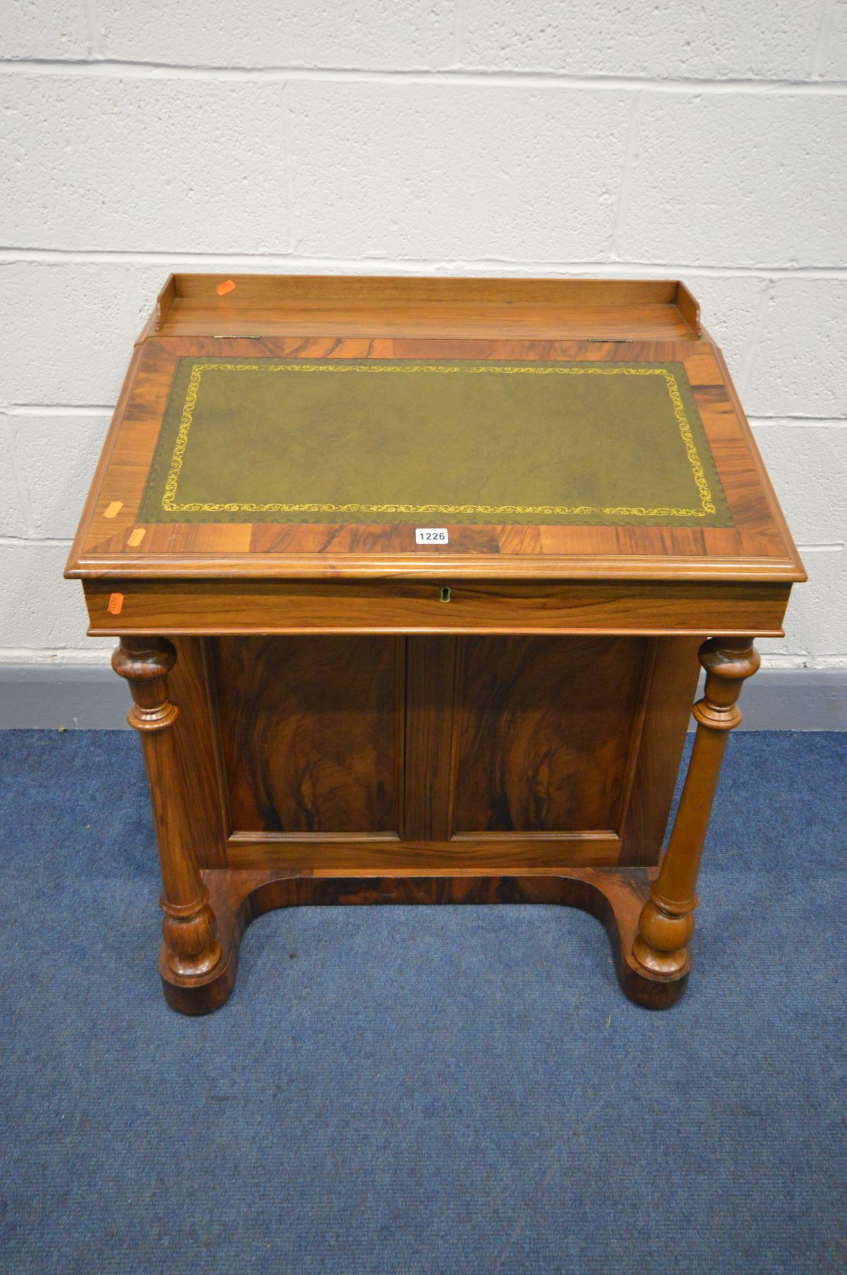 A REPRODUCTION WALNUT DAVENPORT, gallery top, green leather tooled inlaid lid, enclosing four