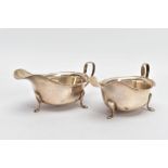 A PAIR OF SILVER SAUCE BOATS, with a plain design and cut rim, each sitting on three raised feet,