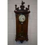 A LATE VICTORIAN WALNUT VIENNA WALL CLOCK, plaster eagle pediment (loose wings) above a glazed