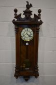A LATE VICTORIAN WALNUT VIENNA WALL CLOCK, plaster eagle pediment (loose wings) above a glazed