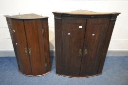 TWO GEORGIAN BARREL FRONT OAK HANGING CORNER CUPBOARDS (two keys)