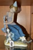 A LLADRO FIGURE GROUP, 'Clown on Saxophone' No. 5059 depicting boy clown with saxophone and puppy,