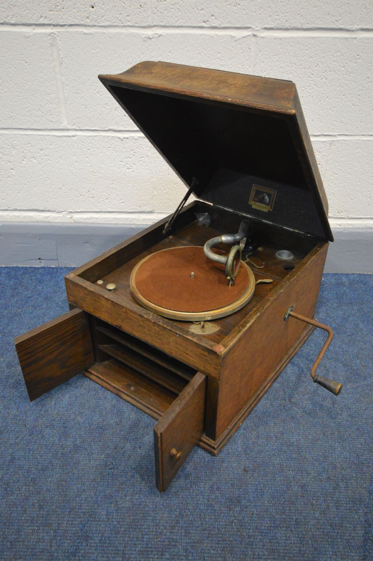 A VINTAGE HIS MASTER'S VOICE TABLE TOP WIND UP GRAMOPHONE (winding handle) (over stained top,