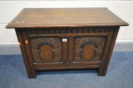AN OAK COFFER with double carved panels, width 84cm x depth 42cm x height 56cm (Sd to finish)