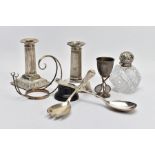 A TRAY OF ASSORTED SILVER ITEMS, to include a pair of column dwarf candlesticks, detailed beaded