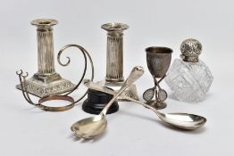 A TRAY OF ASSORTED SILVER ITEMS, to include a pair of column dwarf candlesticks, detailed beaded