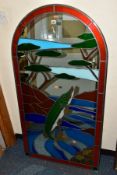 A DECORATIVE ARCHED MIRROR PANEL INSET WITH STAINED GLASS, forming an image of a Pike, a river and