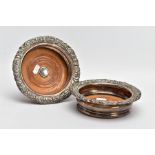 A PAIR OF SILVER-PLATED BOTTLE COASTERS, with embossed floral and foliate decoration to the rims and