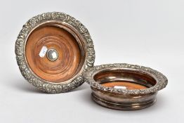 A PAIR OF SILVER-PLATED BOTTLE COASTERS, with embossed floral and foliate decoration to the rims and