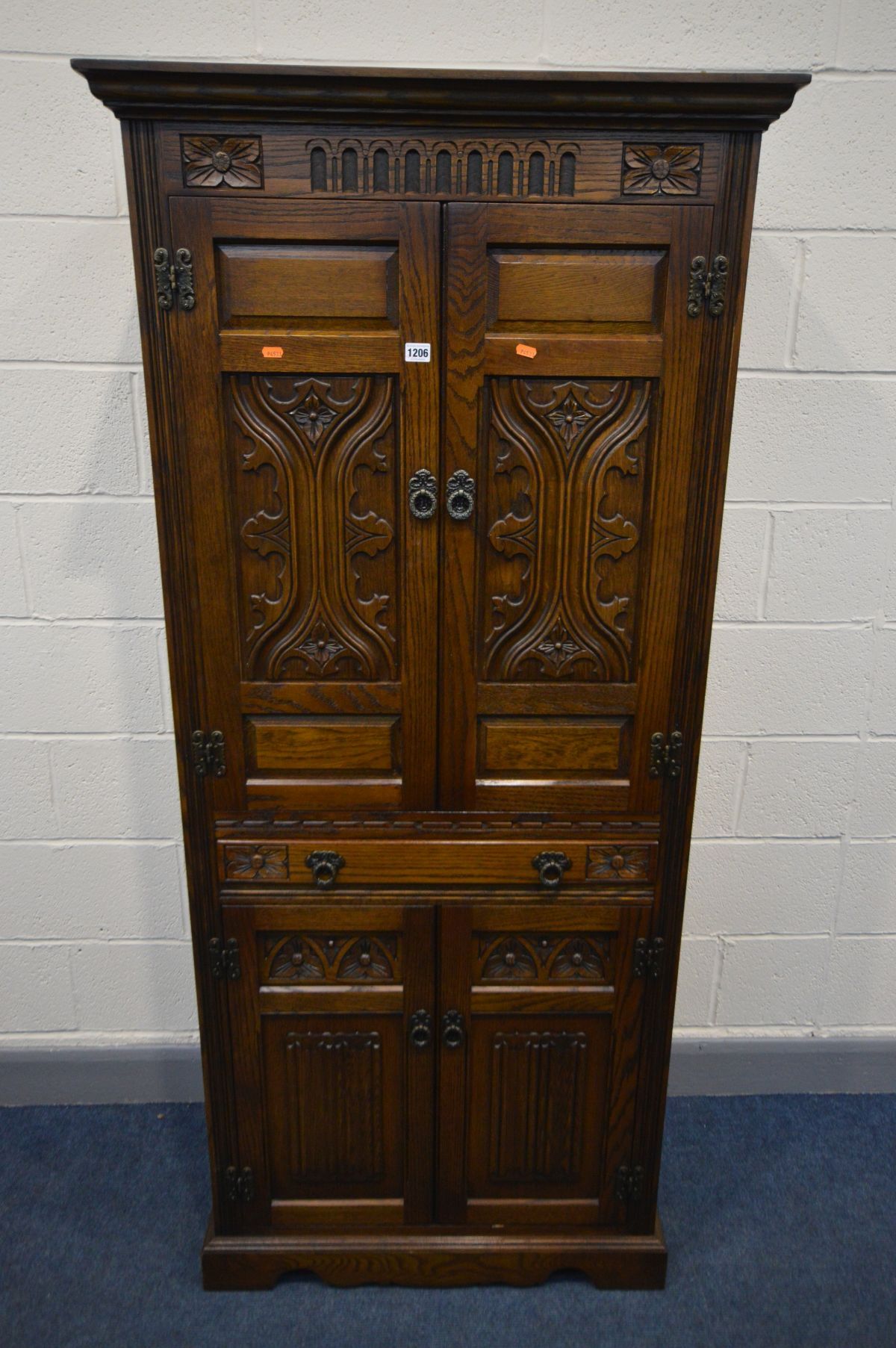 AN OLD CHARM COCKTAIL CABINET, the top section with double doors enclosing two glass shelves and a