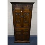 AN OLD CHARM COCKTAIL CABINET, the top section with double doors enclosing two glass shelves and a