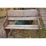 A TEAK GARDEN BENCH with pegged plant sides and wide slatted seat and back Badged Hattersley,