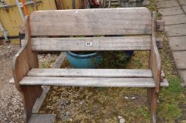 A TEAK GARDEN BENCH with pegged plant sides and wide slatted seat and back Badged Hattersley,