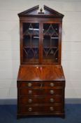 A REPRODUCTION MAHOGANY BUREAU BOOKCASE, in the Georgian style, double glazed door above a fall