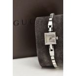 A LADY'S STAINLESS STEEL DIAMOND SET 'GUCCI' WRISTWATCH, quartz movement, square mother of pearl
