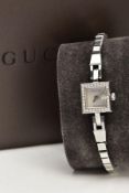 A LADY'S STAINLESS STEEL DIAMOND SET 'GUCCI' WRISTWATCH, quartz movement, square mother of pearl