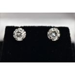 A PAIR OF 14CT WHITE GOLD DIAMOND STUD EARRINGS, each designed with a claw set round brilliant cut