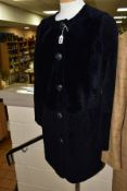 A LADIES TORY BURCH DARK NAVY LAMBSKIN THIGH LENGTH COAT, with pockets and five gilt detail buttons,